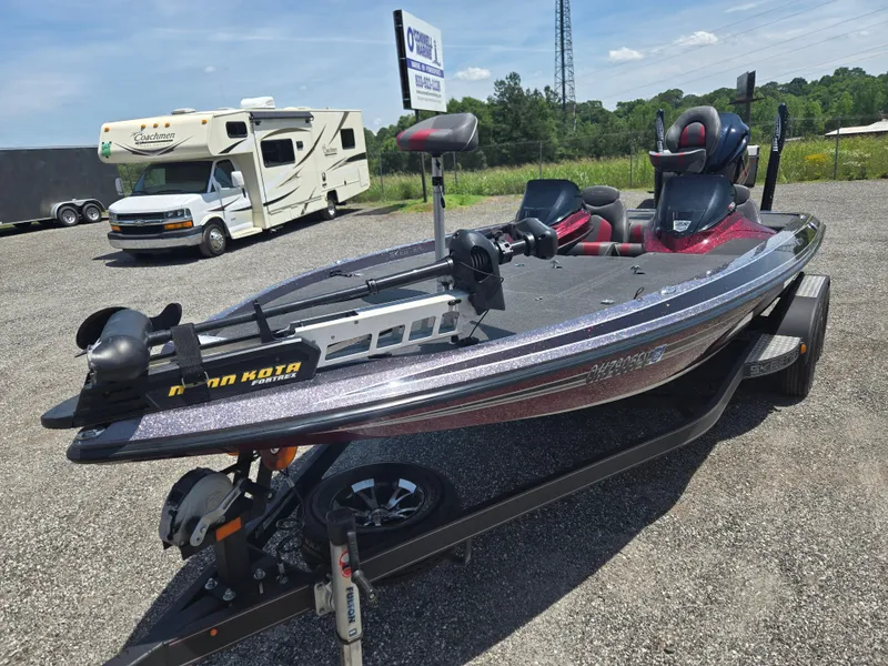 Slide: The Image of 2018 Skeeter ZX 250 bass boat on trailer in outdoor setting. - 13