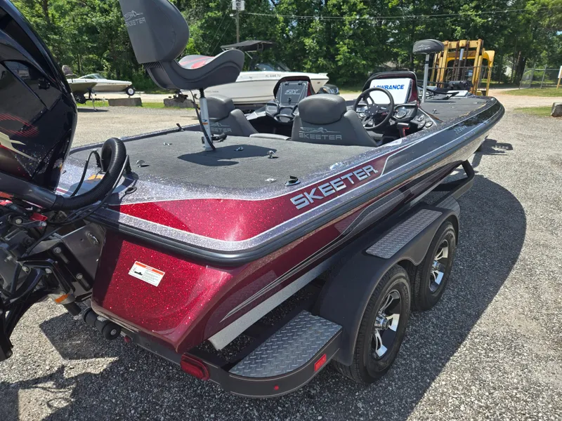 Slide: The Image of 2018 Skeeter ZX 250 bass boat with red finish, parked outdoors. - 19