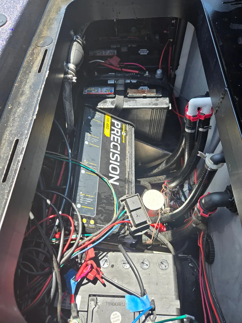 Slide: The Image of 2018 Skeeter ZX 250 boat battery compartment with wiring and Precision charger. - 6