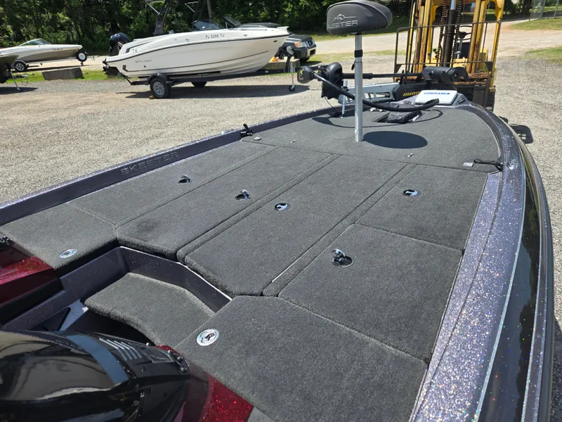 Slide: The Image of 2018 Skeeter ZX 250 boat with spacious deck and fishing seat, parked outdoors. - 8