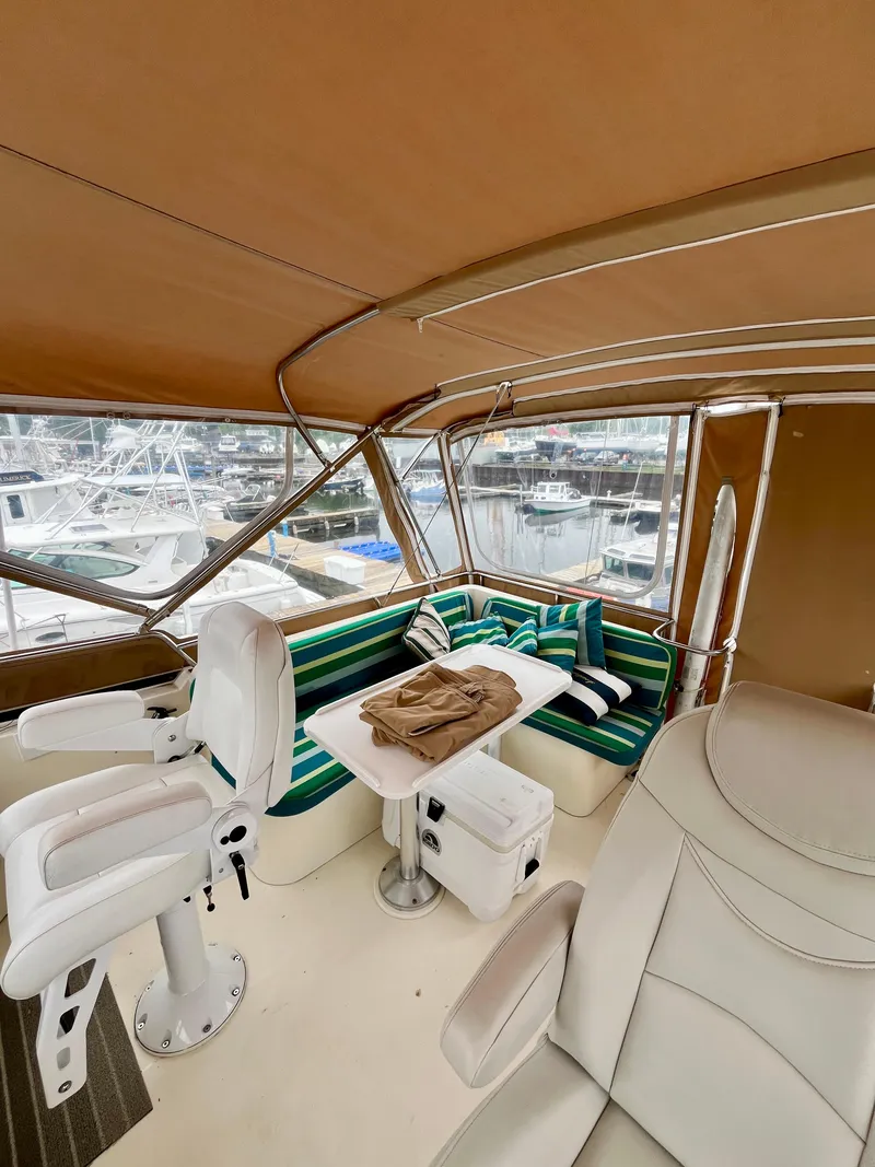 Slide: The Image of 1996 Sabreline 43 Motoryacht interior with seating, table, and helm chairs. - 10