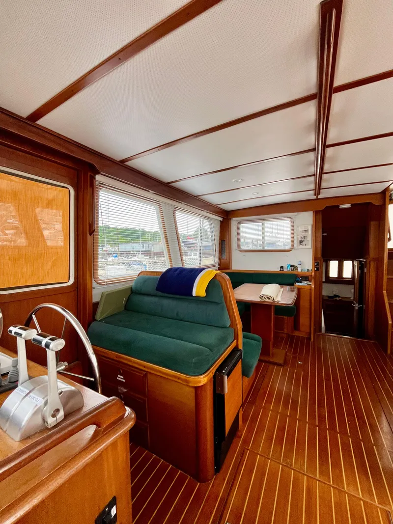 Slide: The Image of Interior of 1996 Sabreline 43 Motoryacht with wooden flooring and green seating. - 15