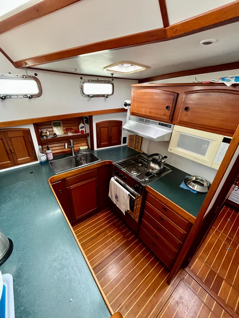Slide: The Image of Interior of 1996 Sabreline 43 Motoryacht kitchen with wood cabinetry and modern appliances. - 17