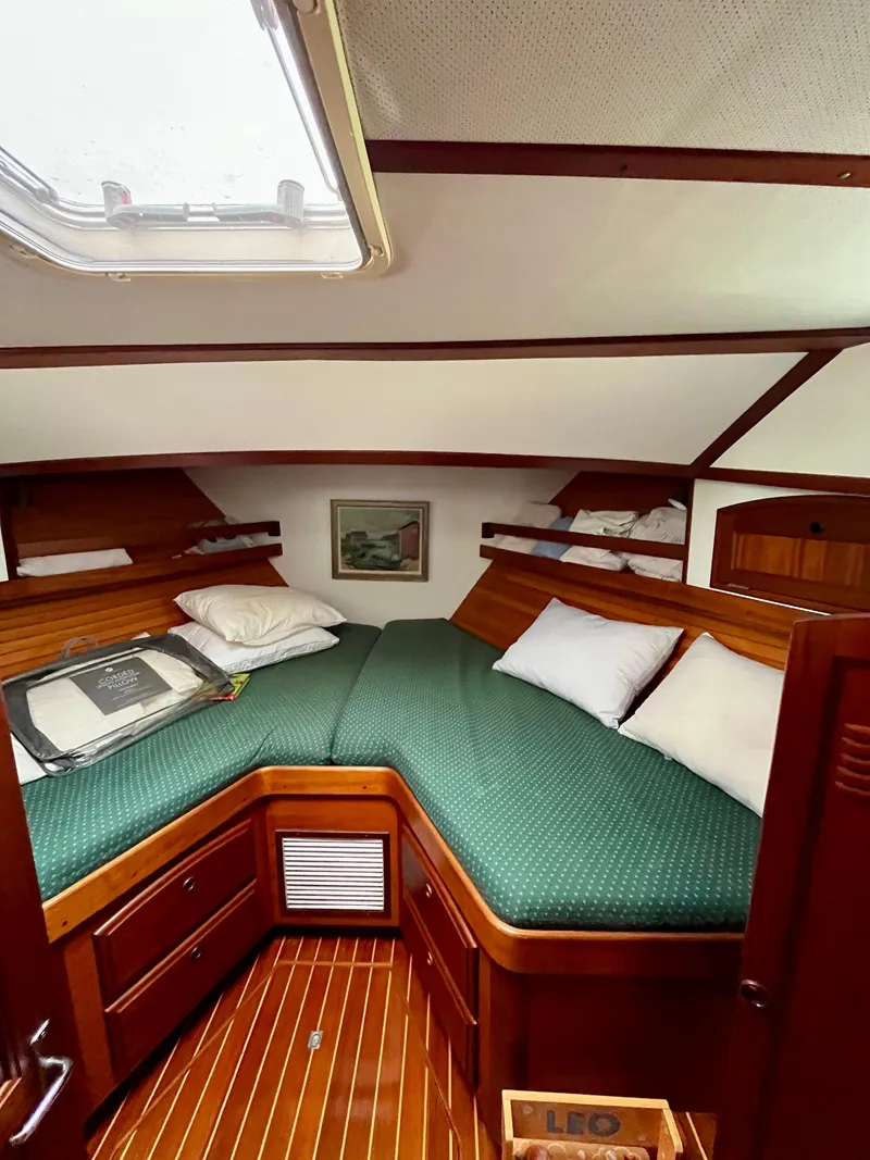 Slide: The Image of 1996 Sabreline 43 Motoryacht cabin with green bedding and wooden interior. - 19