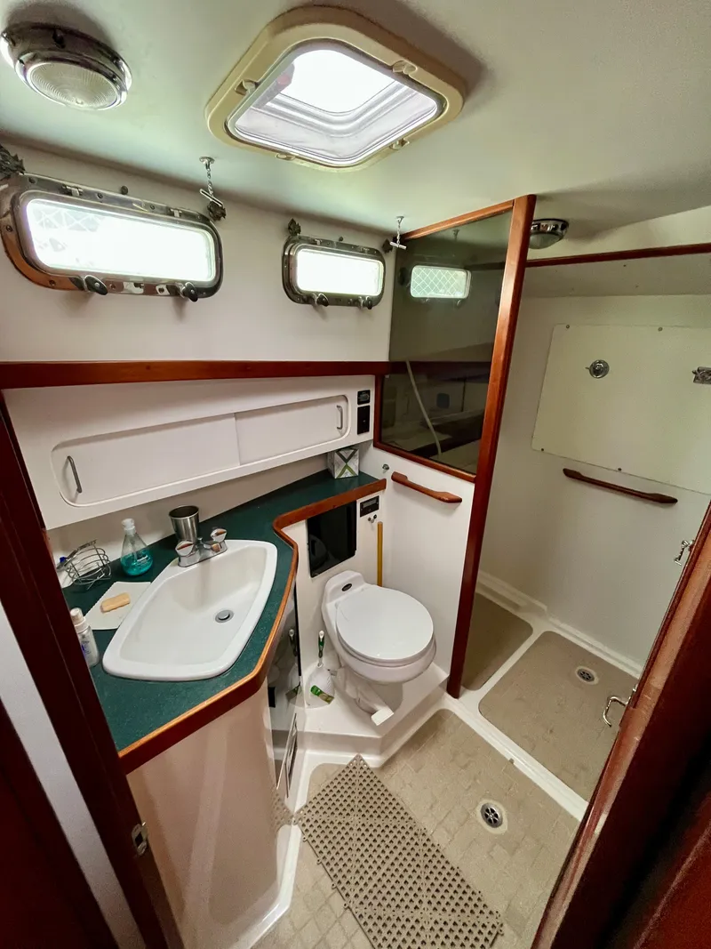 Slide: The Image of 1996 Sabreline 43 Motoryacht bathroom with sink, toilet, and shower. - 20
