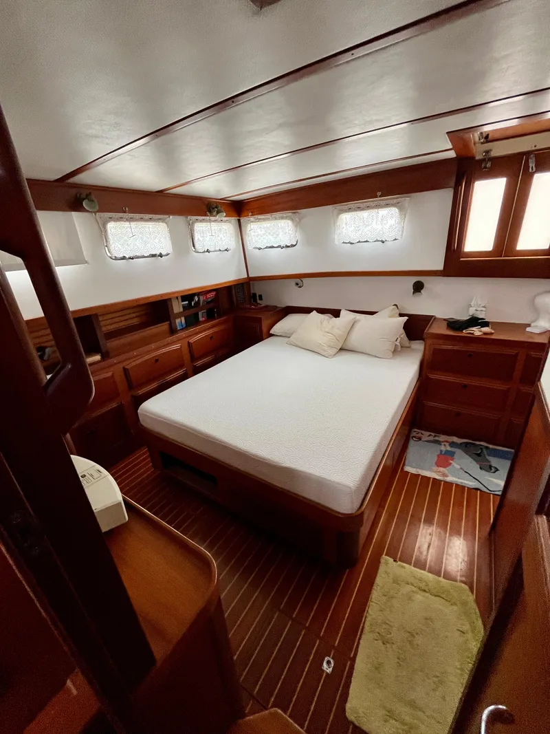 Slide: The Image of Interior of 1996 Sabreline 43 Motoryacht with cozy bedroom and wooden furnishings. - 22