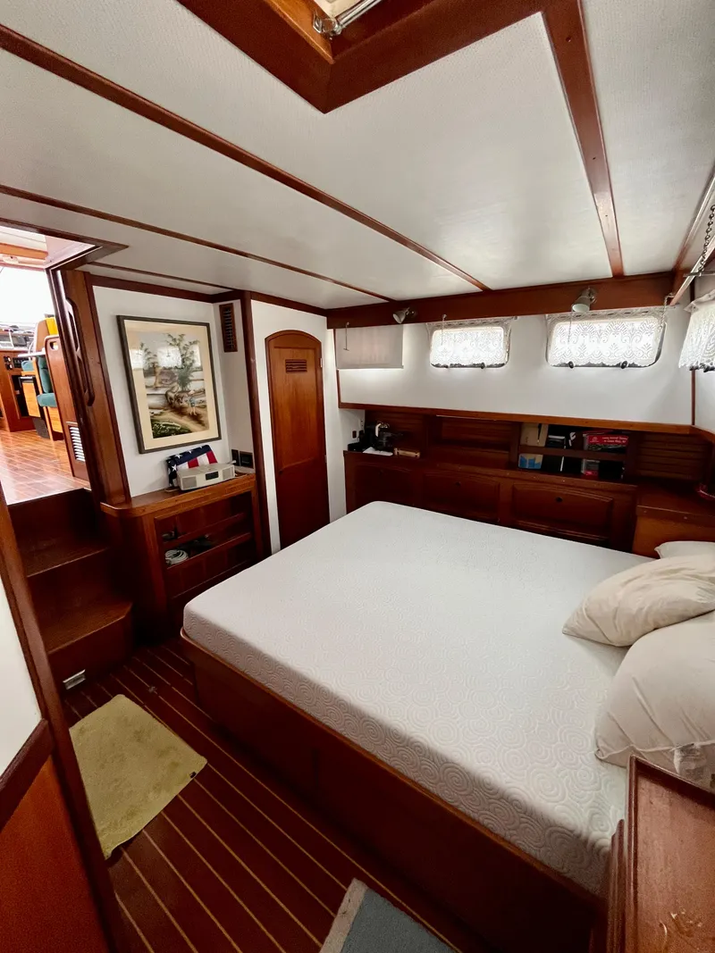 Slide: The Image of Interior of 1996 Sabreline 43 Motoryacht with cozy bedroom and wooden accents. - 23
