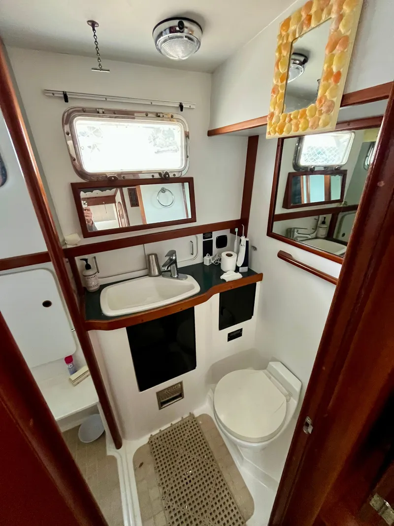 Slide: The Image of Bathroom interior of 1996 Sabreline 43 Motoryacht with sink, toilet, and mirror. - 24
