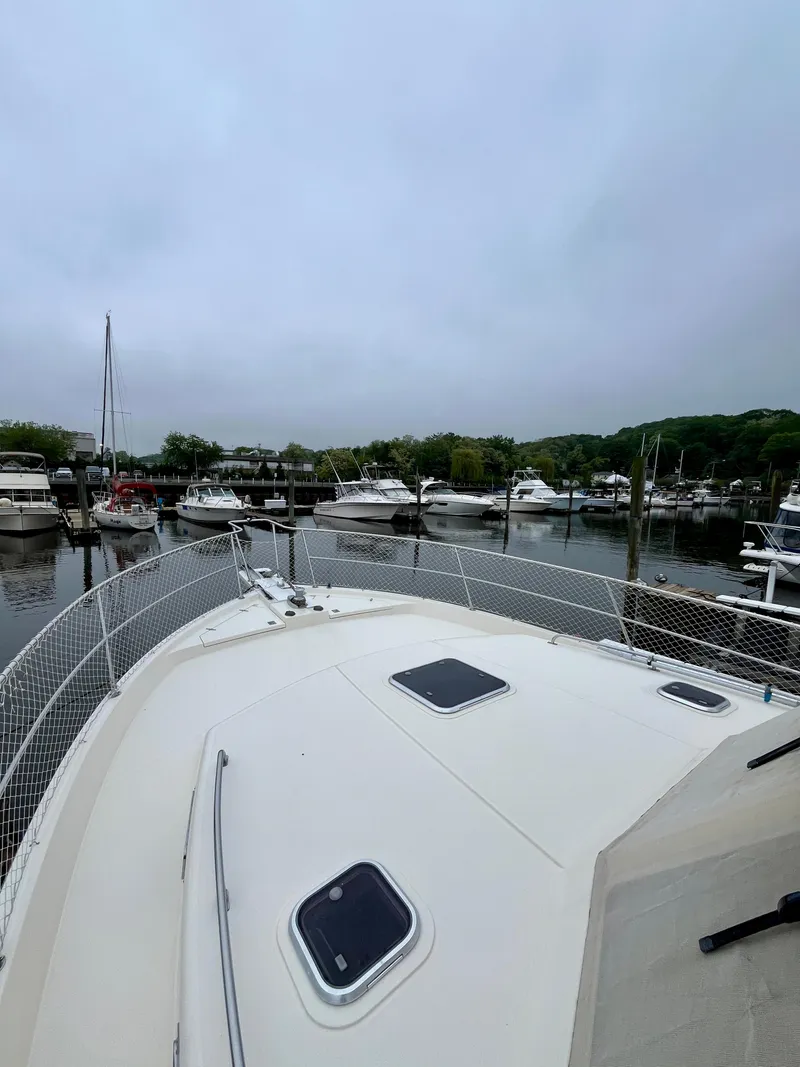 Slide: The Image of 1996 Sabreline 43 Motoryacht docked in a marina, surrounded by other boats. - 5