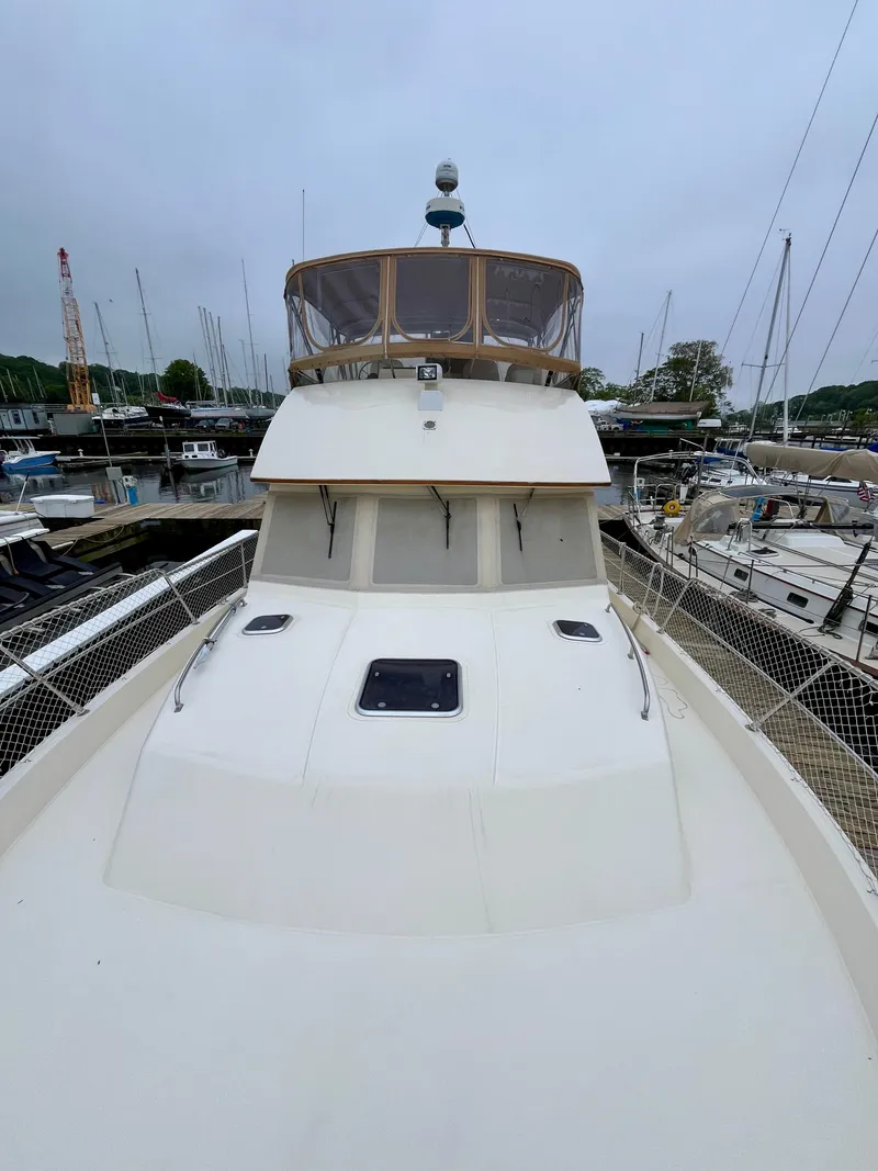 Slide: The Image of 1996 Sabreline 43 Motoryacht docked at marina, view from bow. - 6