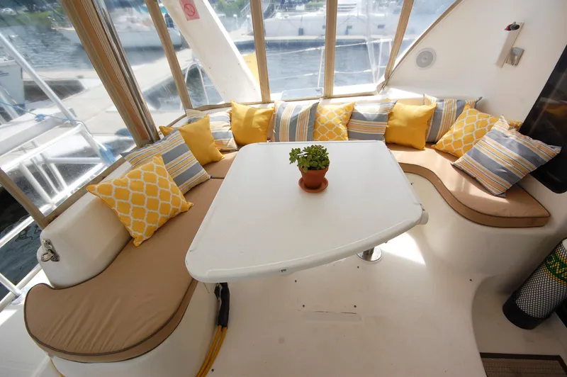 Slide: The Image of Cozy seating area on 2007 Leopard 43 yacht with colorful cushions and table. - 10
