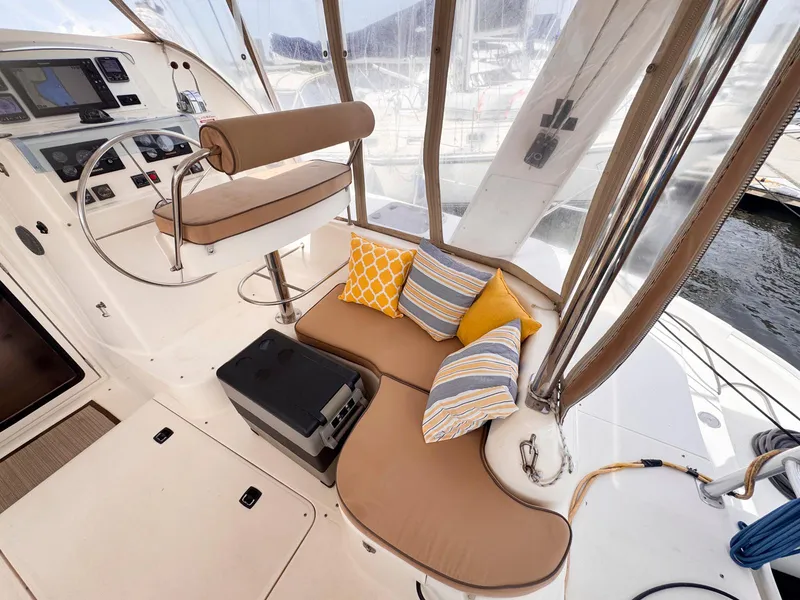 Slide: The Image of Helm area of 2007 Leopard 43 yacht with cushioned seating and colorful pillows. - 11