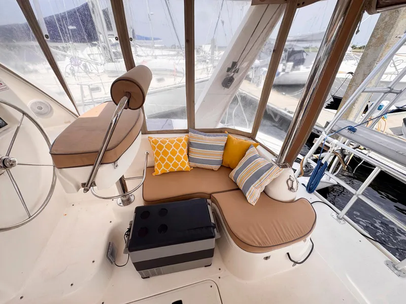 Slide: The Image of Cozy seating area on a 2007 Leopard 43 yacht with colorful cushions and helm station. - 12