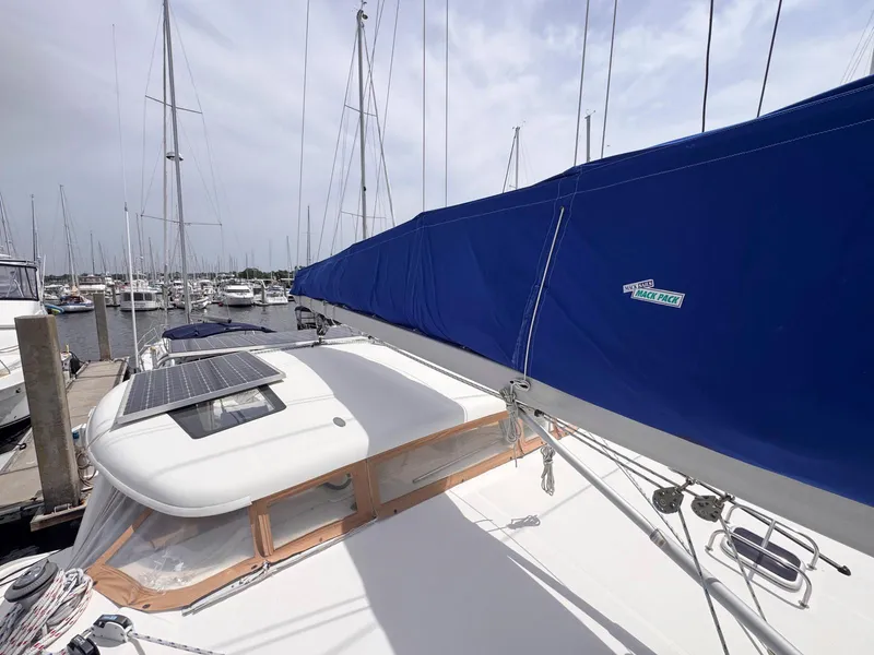 Slide: The Image of 2007 Leopard 43 catamaran with blue sail cover and solar panel, docked at marina. - 15