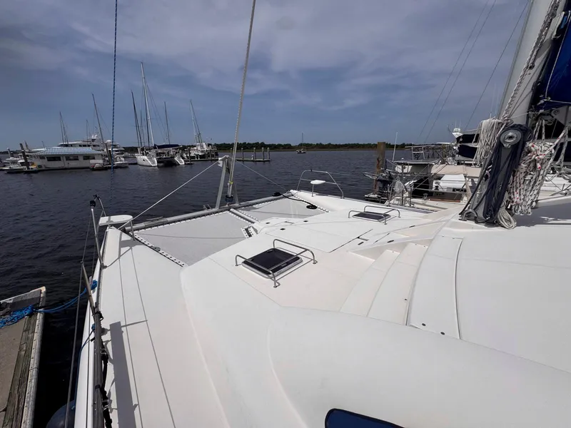 Slide: The Image of 2007 Leopard 43 catamaran docked at a marina under a cloudy sky. - 17
