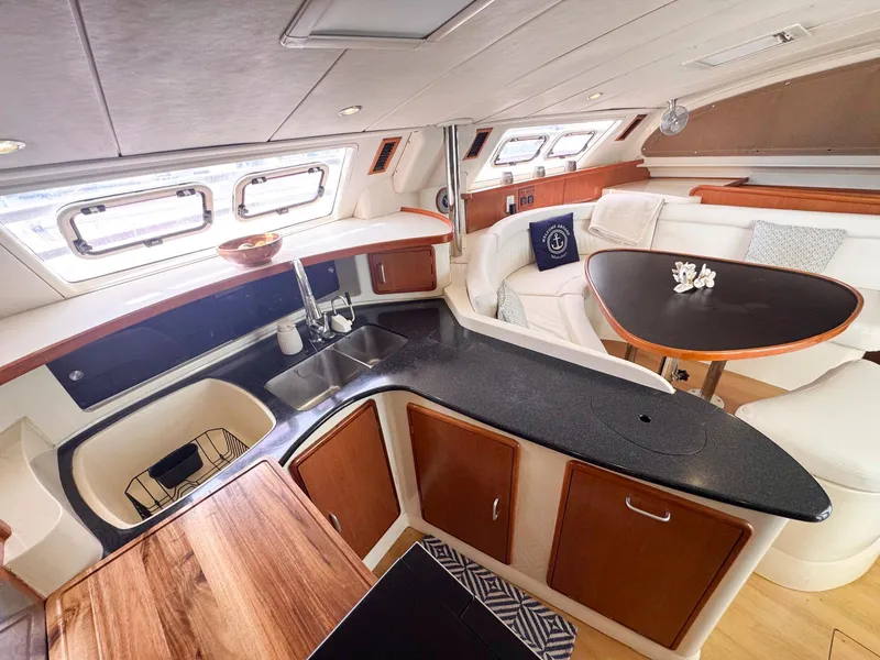 Slide: The Image of Luxurious interior of a 2007 Leopard 43 yacht with modern kitchen and seating area. - 21