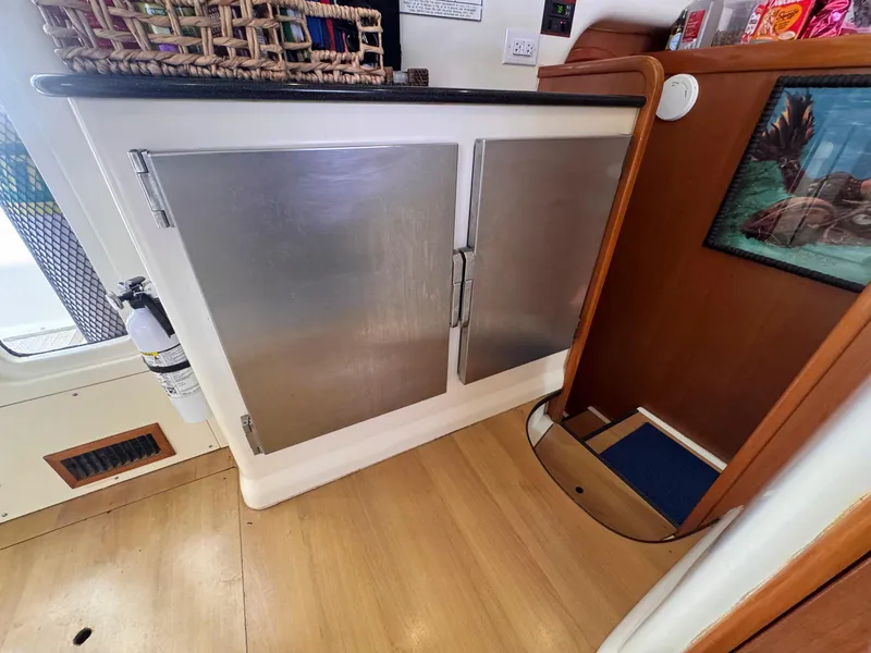 Slide: The Image of Interior of a 2007 Leopard 43 yacht with metal cabinets and wooden flooring. - 23