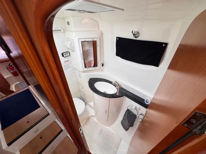 Slide: The Image of Compact bathroom in 2007 Leopard 43 yacht with sink, toilet, and mirror. - 24