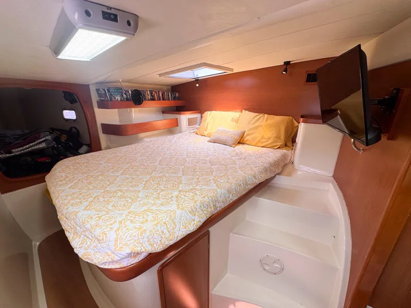 Slide: The Image of Cozy bedroom in 2007 Leopard 43 yacht with a comfortable bed and modern amenities. - 25