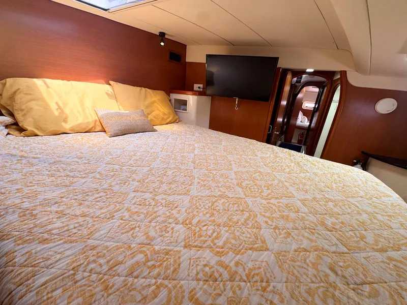 Slide: The Image of Luxurious cabin interior of 2007 Leopard 43 yacht with cozy bedding and modern amenities. - 27