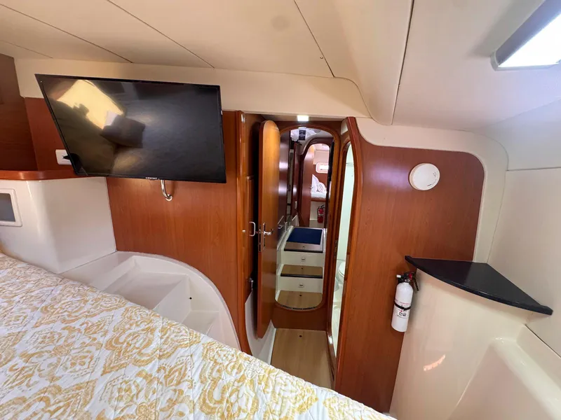 Slide: The Image of Interior of 2007 Leopard 43 yacht with wood paneling and mounted TV. - 28