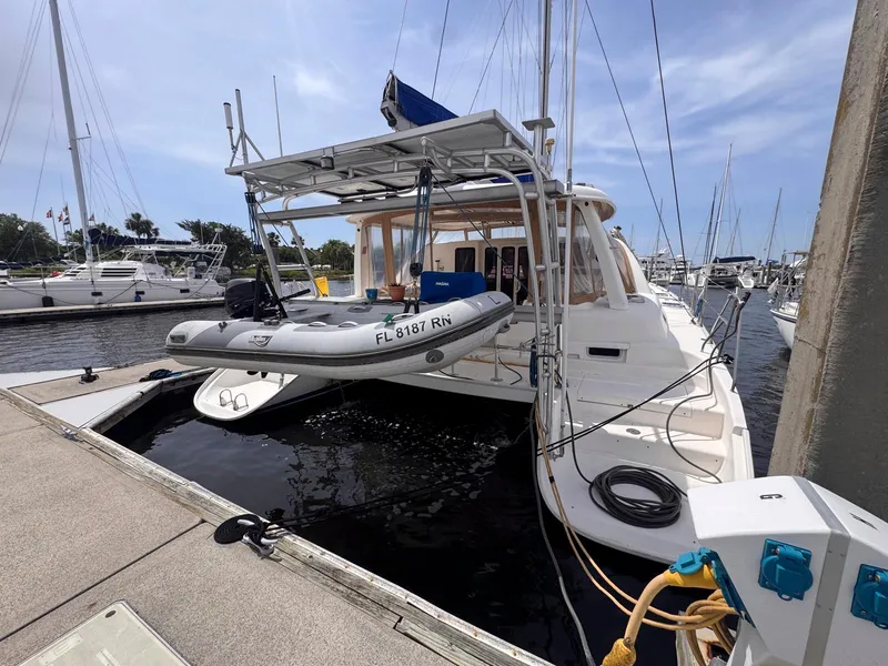 Slide: The Image of Catamaran Leopard 43, 2007 model, docked with dinghy at marina. - 3
