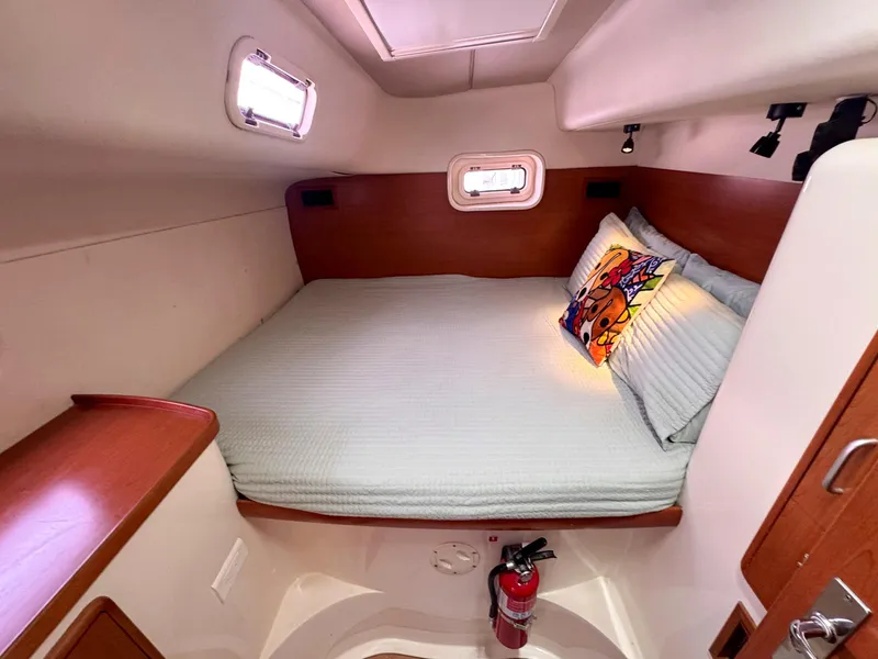 Slide: The Image of Cozy cabin interior of 2007 Leopard 43 yacht with bed, pillows, and fire extinguisher. - 31