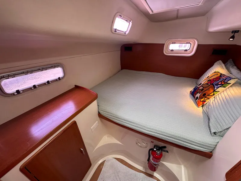 Slide: The Image of Cozy cabin interior of 2007 Leopard 43 yacht with bed and portholes. - 32