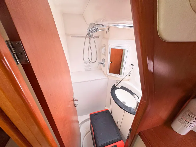 Slide: The Image of Compact bathroom in a 2007 Leopard 43 yacht, featuring a shower and sink. - 33