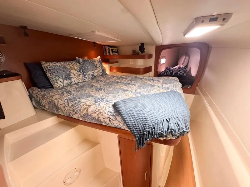 Slide: The Image of Luxurious cabin interior of a 2007 Leopard 43 yacht with cozy bedding and ambient lighting. - 35