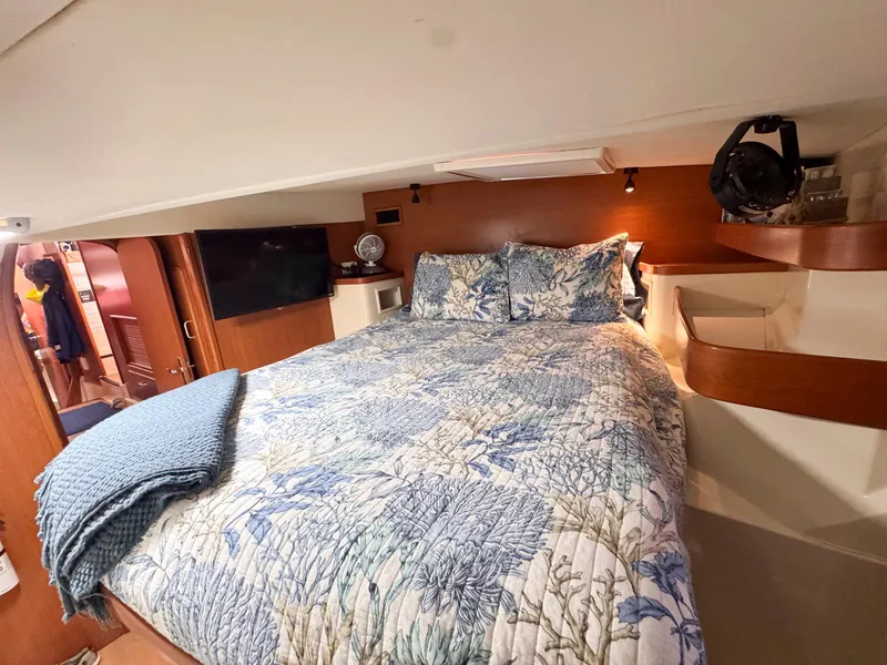 Slide: The Image of Cozy bedroom in 2007 Leopard 43 yacht with floral bedding and wooden accents. - 36