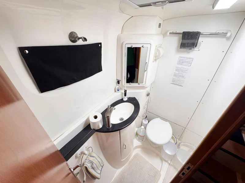 Slide: The Image of Bathroom interior of 2007 Leopard 43 yacht, featuring sink, toilet, and towel rack. - 37