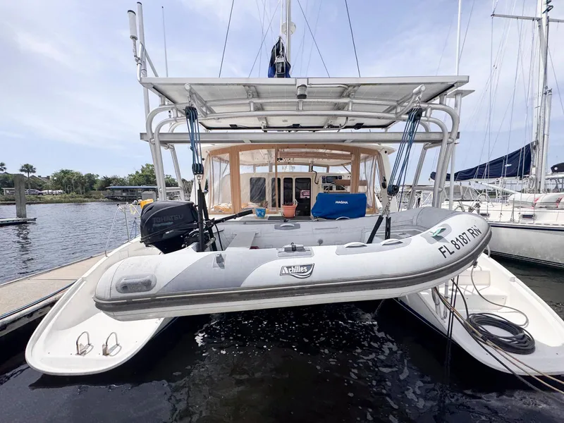 Slide: The Image of 2007 Leopard 43 catamaran with dinghy docked at marina. - 4