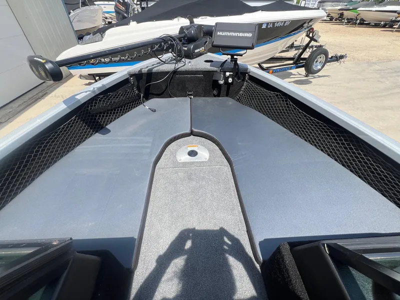 Slide: The Image of 2007 Lund 1800 Pro-V SE boat deck with Humminbird equipment, parked on a trailer. - 11