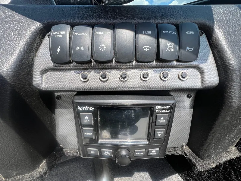 Slide: The Image of Control panel of a 2007 Lund 1800 Pro-V SE boat with switches and Bluetooth stereo. - 21
