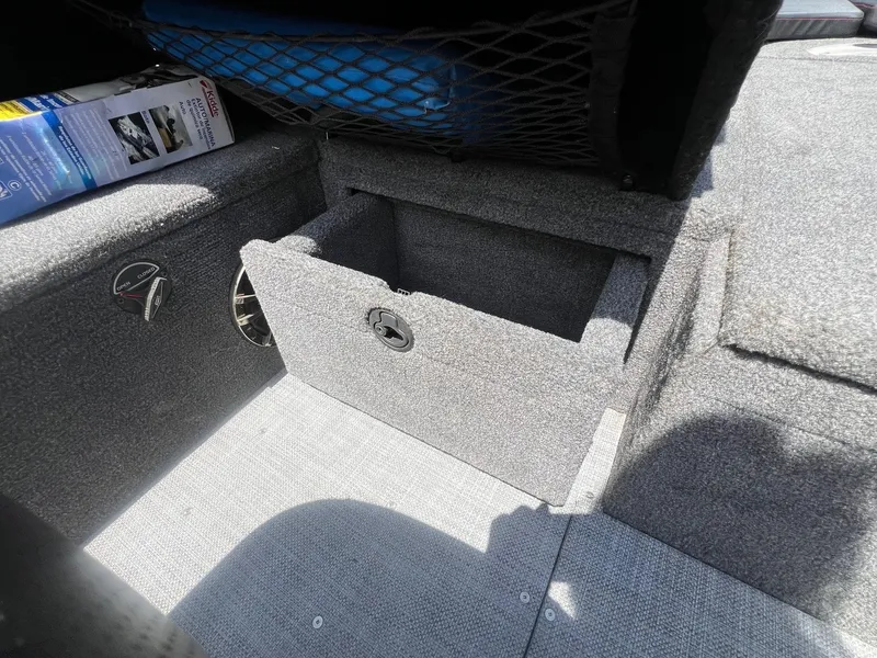 Slide: The Image of 2007 Lund 1800 Pro-V SE boat storage compartment with carpeted interior and netted storage above. - 25