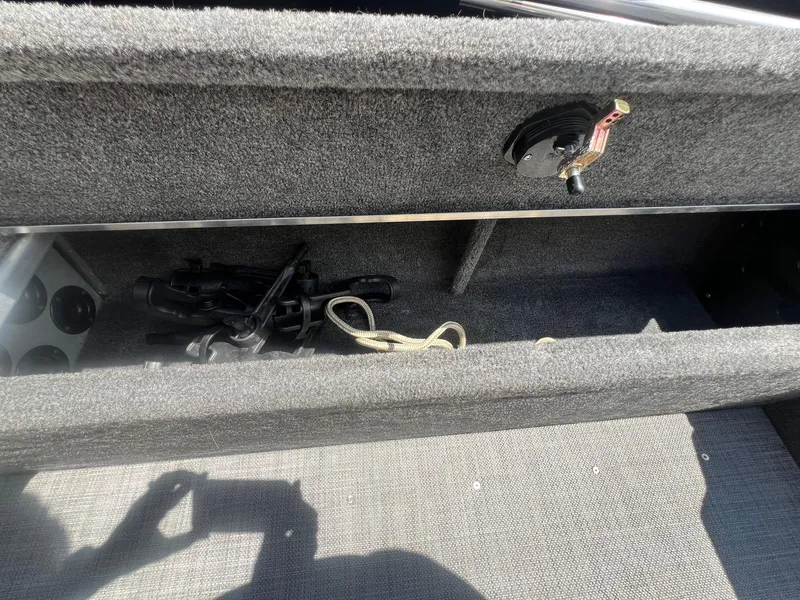 Slide: The Image of Interior storage compartment of a 2007 Lund 1800 Pro-V SE boat, showing equipment and accessories. - 29