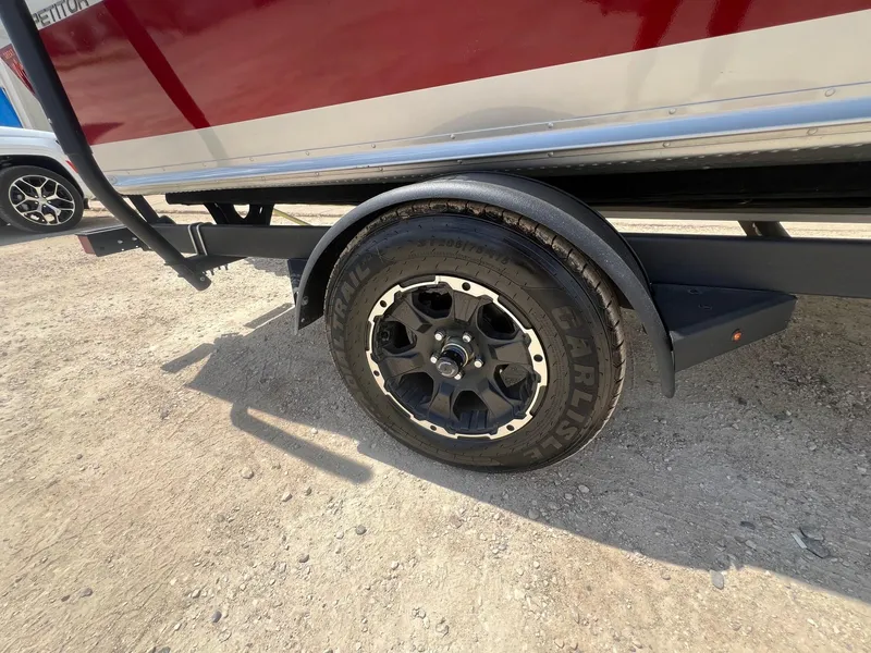 Slide: The Image of Trailer wheel of a 2007 Lund 1800 Pro-V SE boat on gravel. - 32