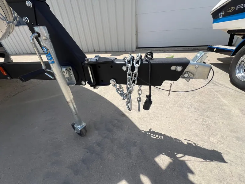 Slide: The Image of Trailer hitch of 2007 Lund 1800 Pro-V SE boat, featuring safety chains and wiring. - 34
