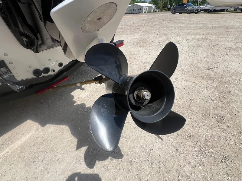 Slide: The Image of Propeller of a 2007 Lund 1800 Pro-V SE boat on a gravel surface. - 9