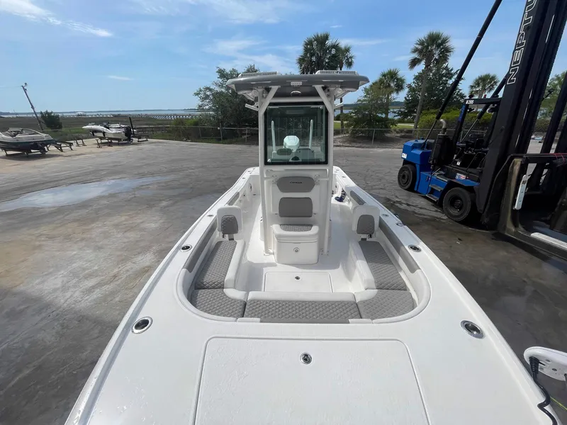 Slide: The Image of 2023 Caymas 26 HB boat on dry dock, featuring spacious deck and modern design. - 11