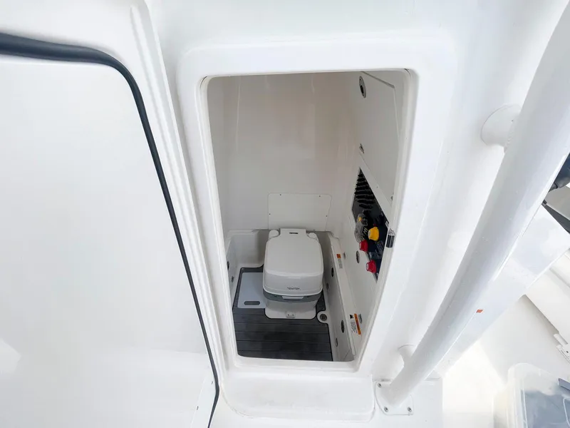 Slide: The Image of 2023 Caymas 26 HB boat interior with compact marine toilet. - 13