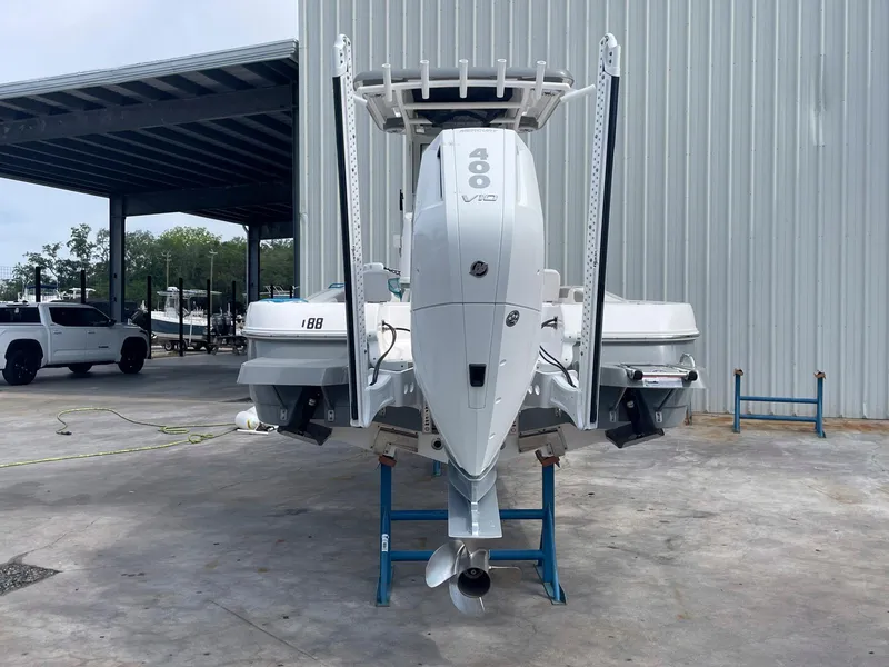 Slide: The Image of 2023 Caymas 26 HB boat with powerful 400 V10 engine, docked in a marina. - 3