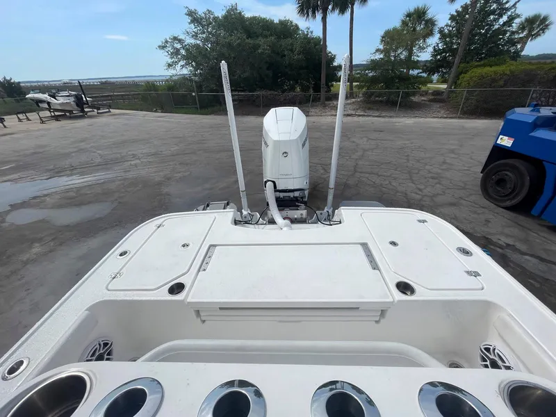 Slide: The Image of 2023 Caymas 26 HB boat stern view with outboard motor and rod holders. - 4