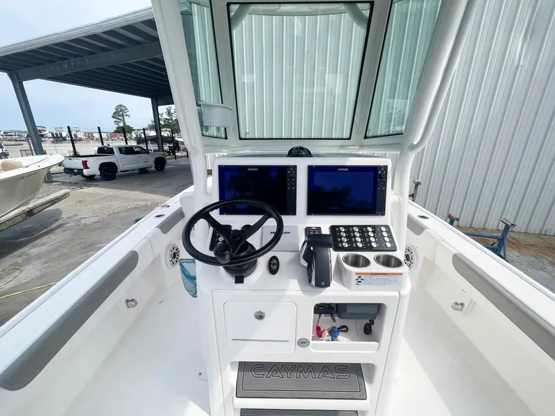 Slide: The Image of 2023 Caymas 26 HB boat console with dual screens and steering wheel. - 7