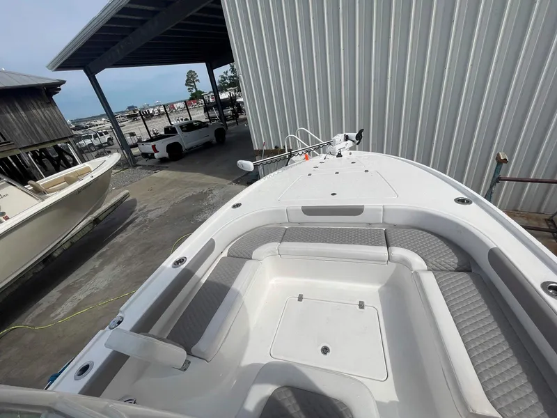Slide: The Image of 2023 Caymas 26 HB boat docked, featuring spacious seating and modern design. - 9