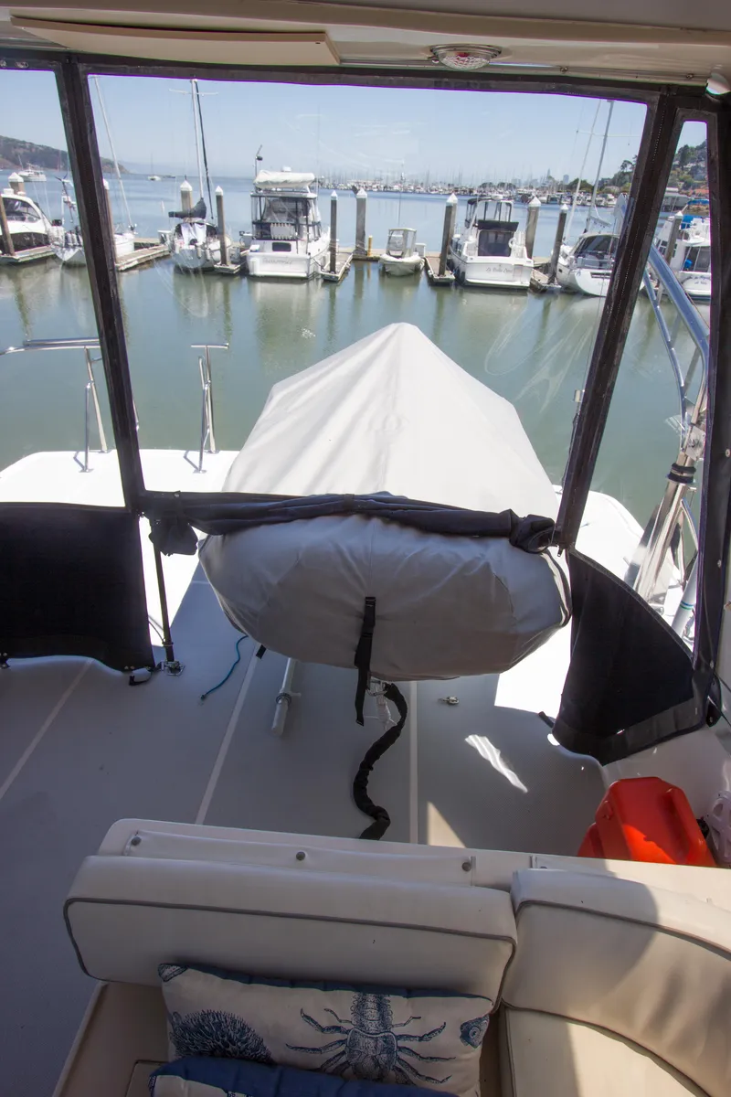 Slide: The Image of 1992 Offshore Yachts Sedan at marina, view from interior to docked boats. - 22