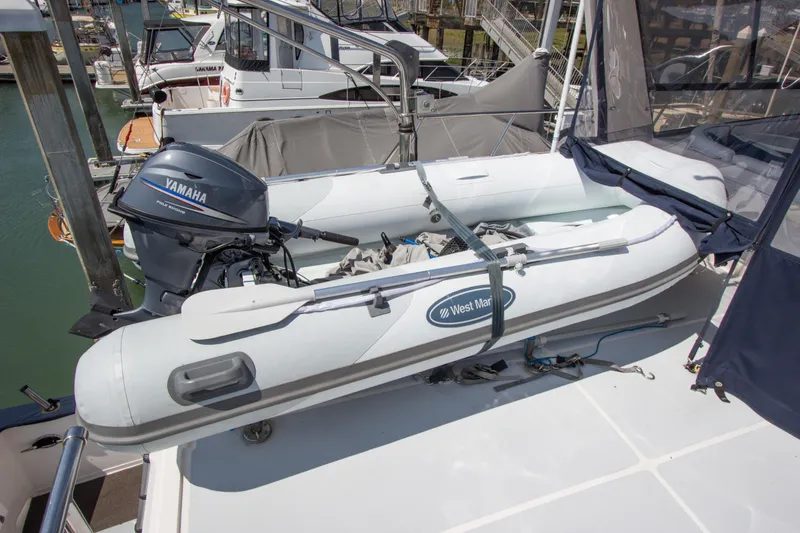 Slide: The Image of 1992 Offshore Yachts Sedan with West Marine inflatable boat and Yamaha motor on deck. - 23