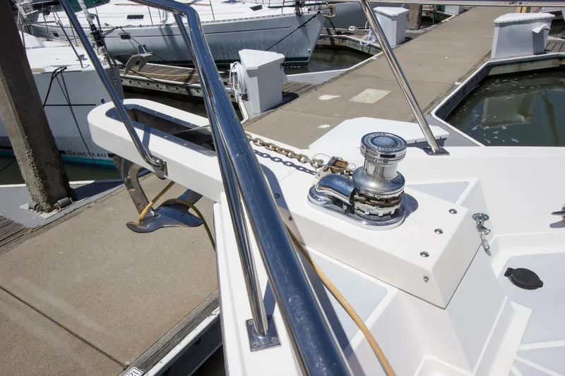 Slide: The Image of Bow of 1992 Offshore Yachts Sedan with anchor and winch at marina. - 25