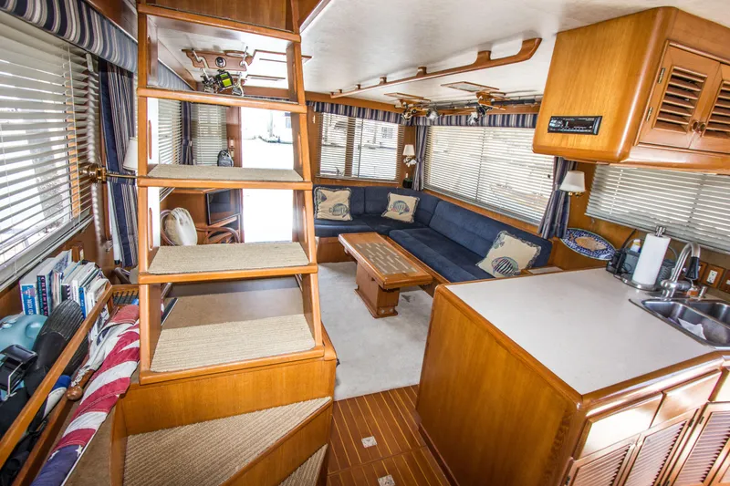Slide: The Image of Interior of 1992 Offshore Yachts Sedan with cozy seating and wooden finishes. - 3